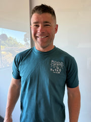 Dad wearing his daughter's family drawing embroidered on a teal RK Threads tee